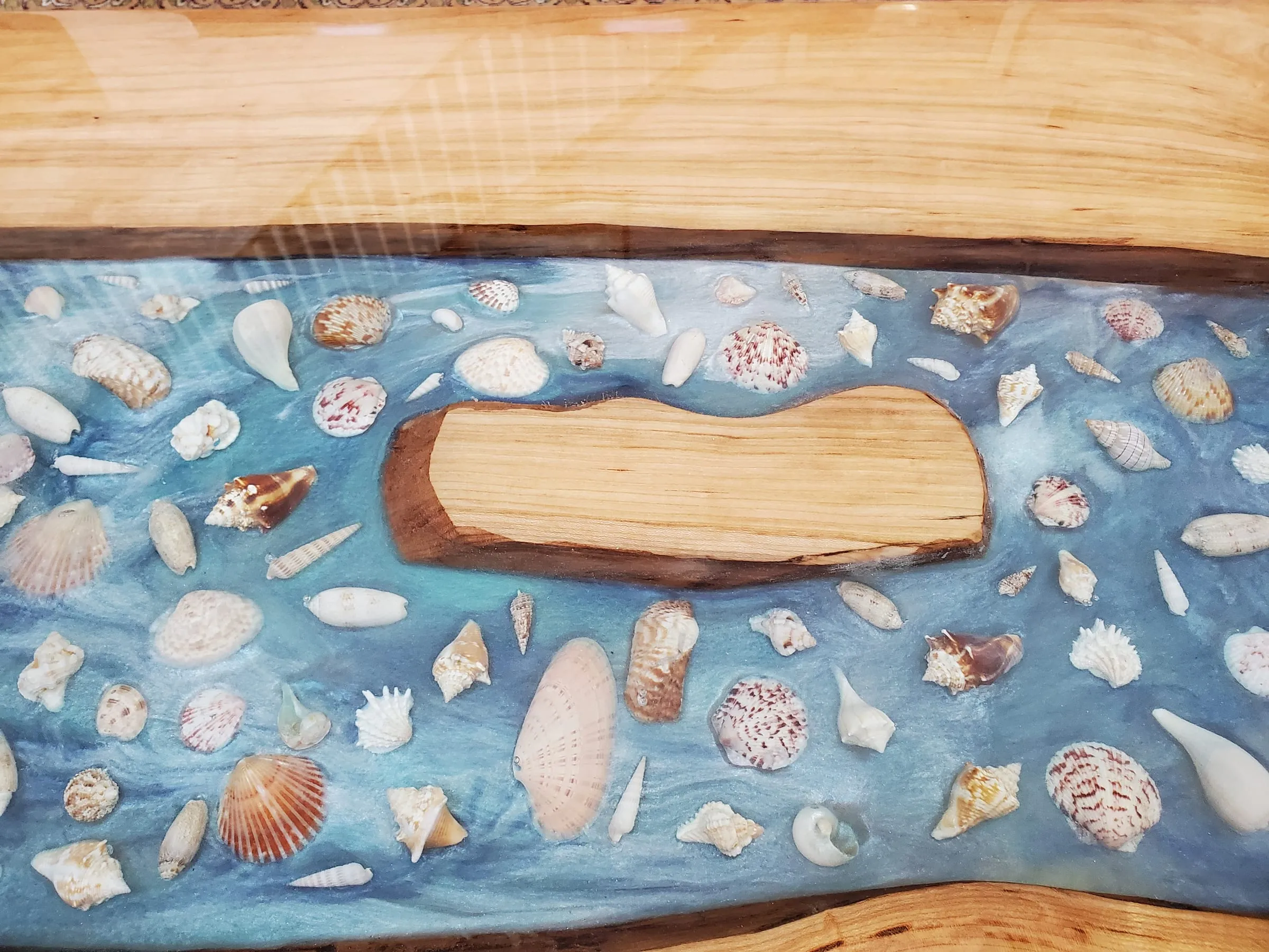 Coffee River Table — A live-edge island among the shells