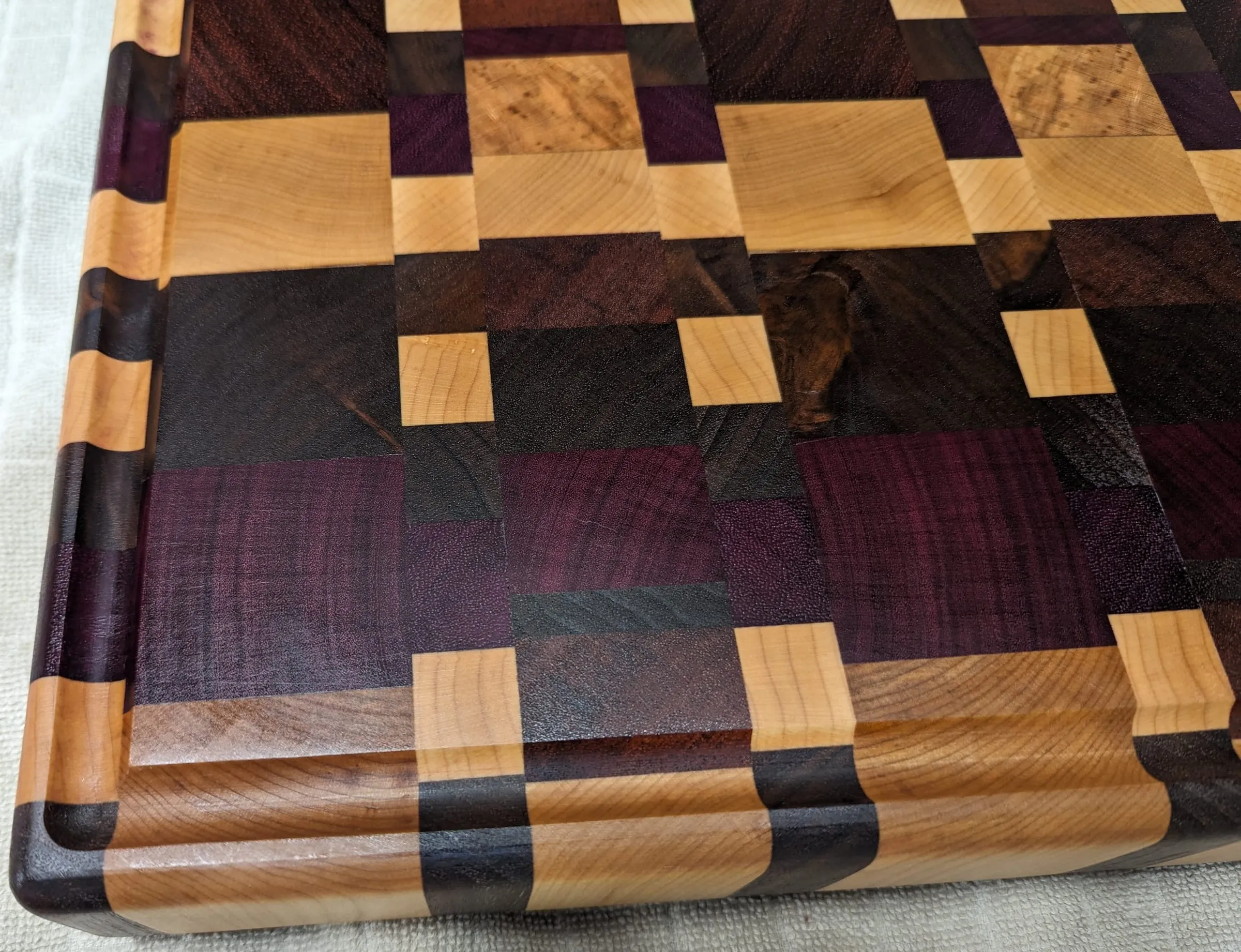 End-Grain Boards & Bowls — Close-up: burl squares in a purpleheart mosaic