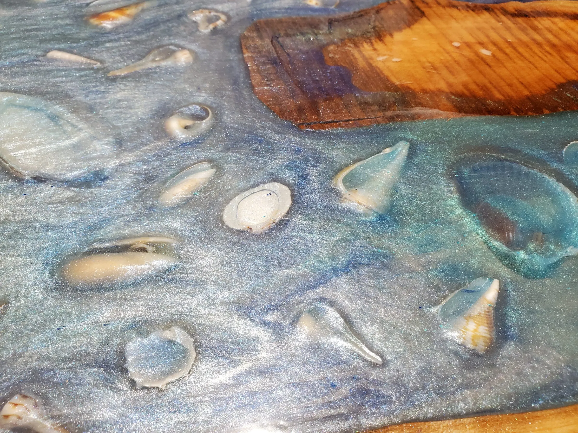 Coffee River Table — Shells set in swirled blue and white epoxy