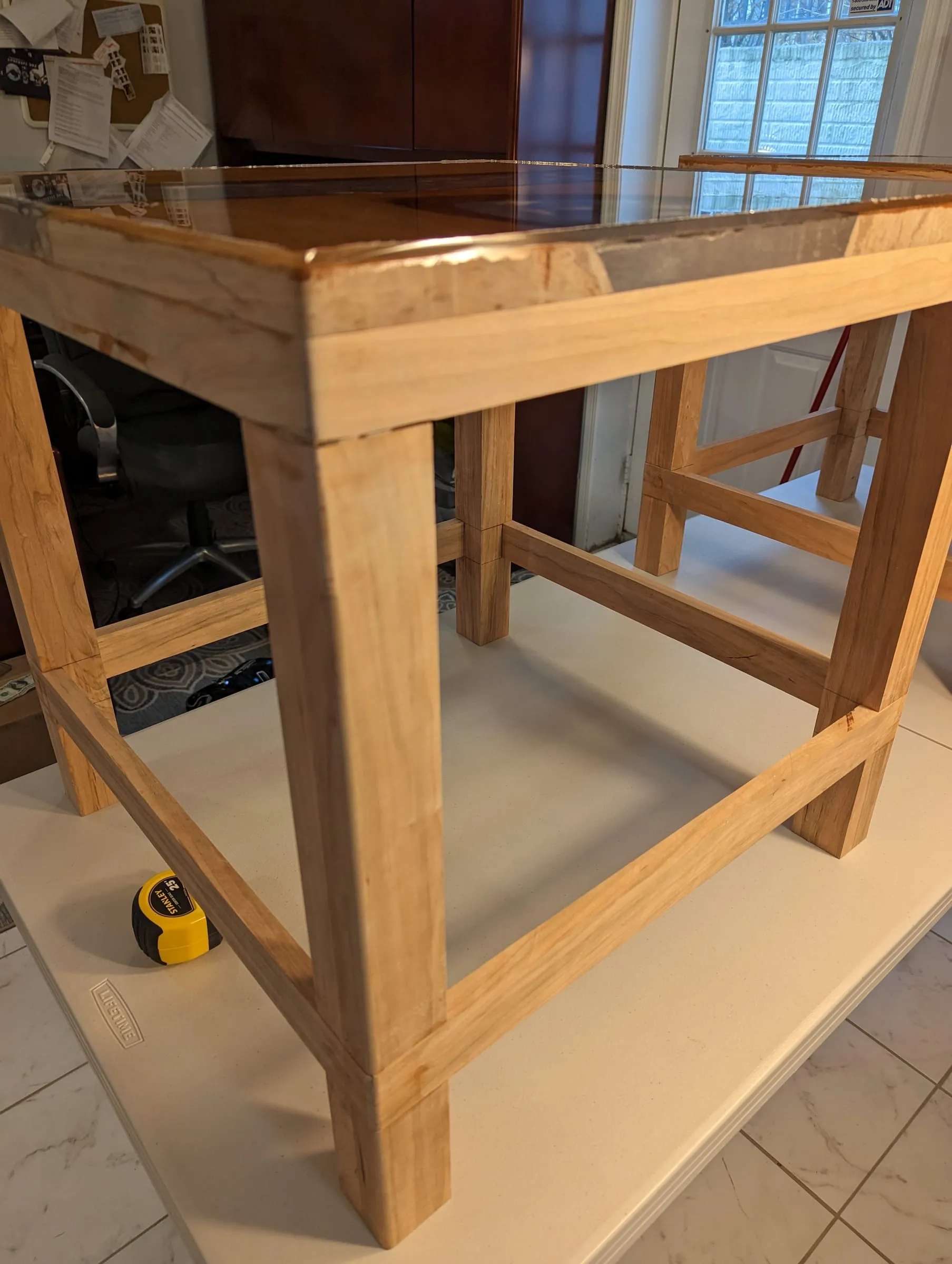River End Table — Corner view of the leg-and-stretcher base