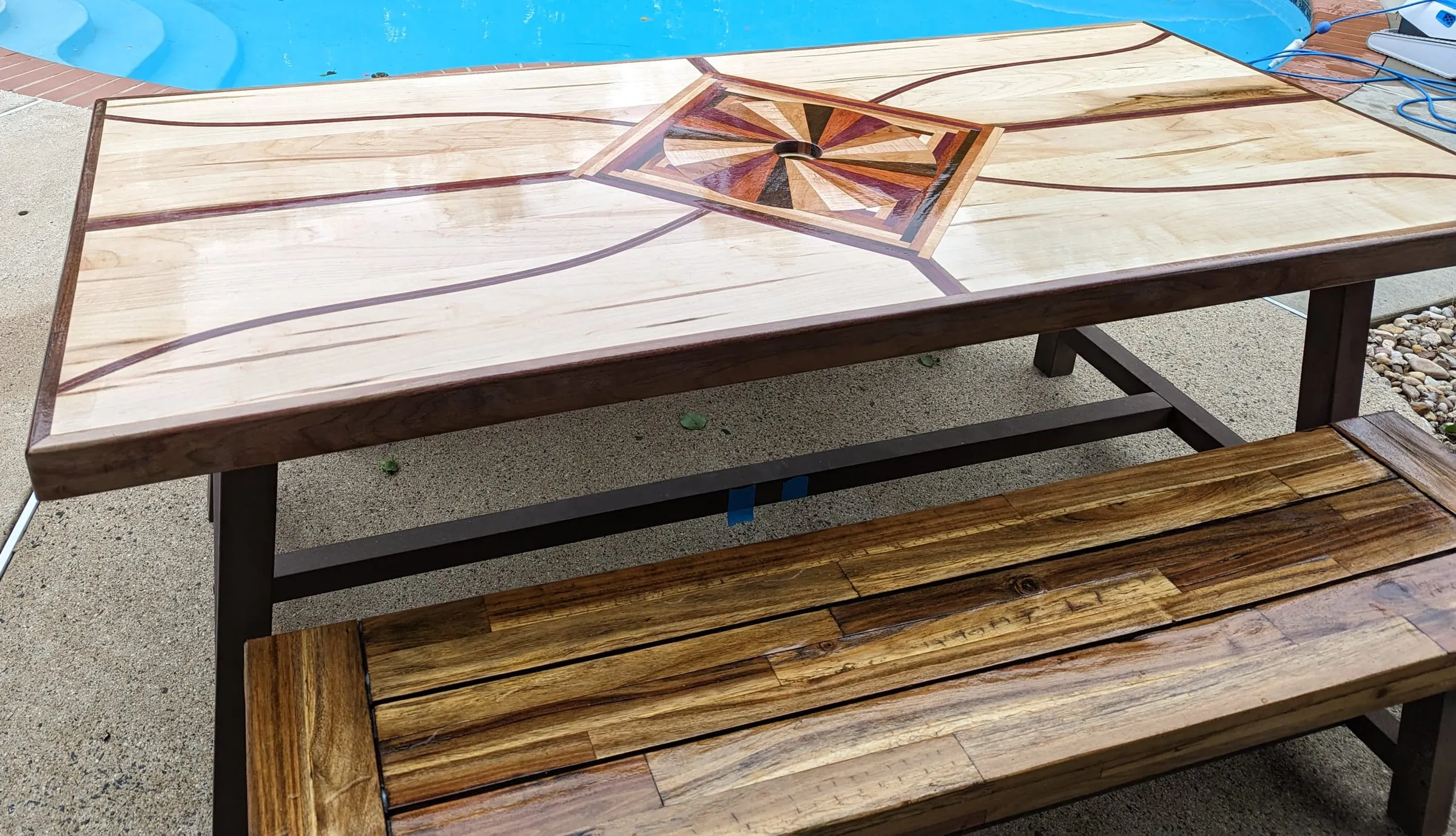 The Starburst Picnic Table — Top and varnished wood bench seat