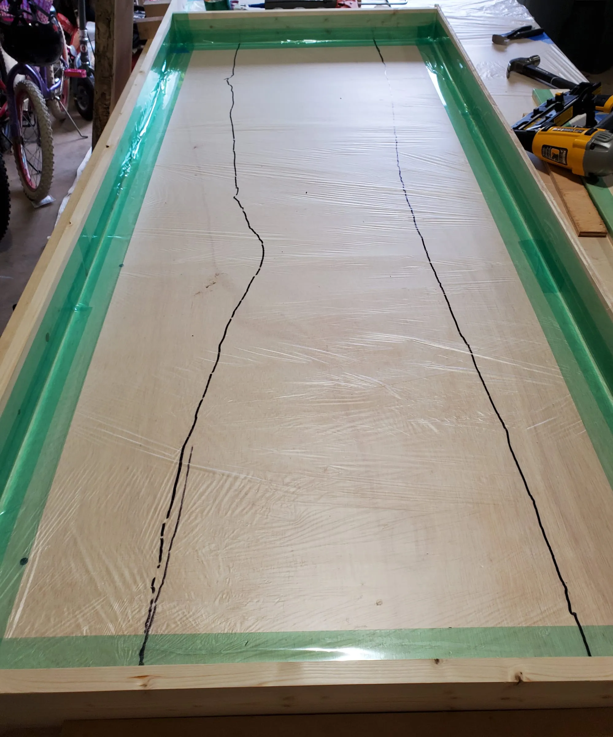 The Outdoor River Table — The sealed frame, with the river outlined on the base