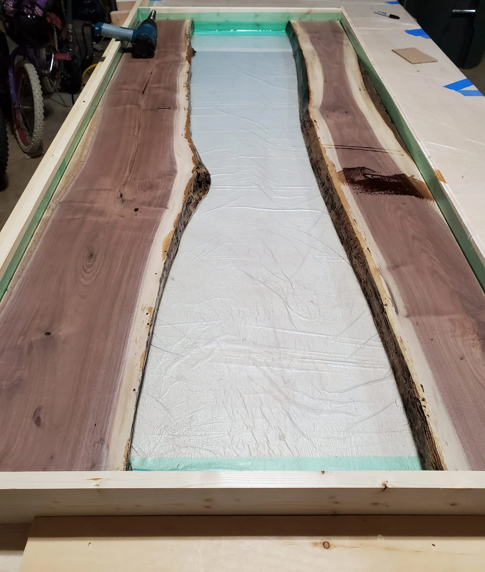 The Outdoor River Table — Slabs in place, river cavity open