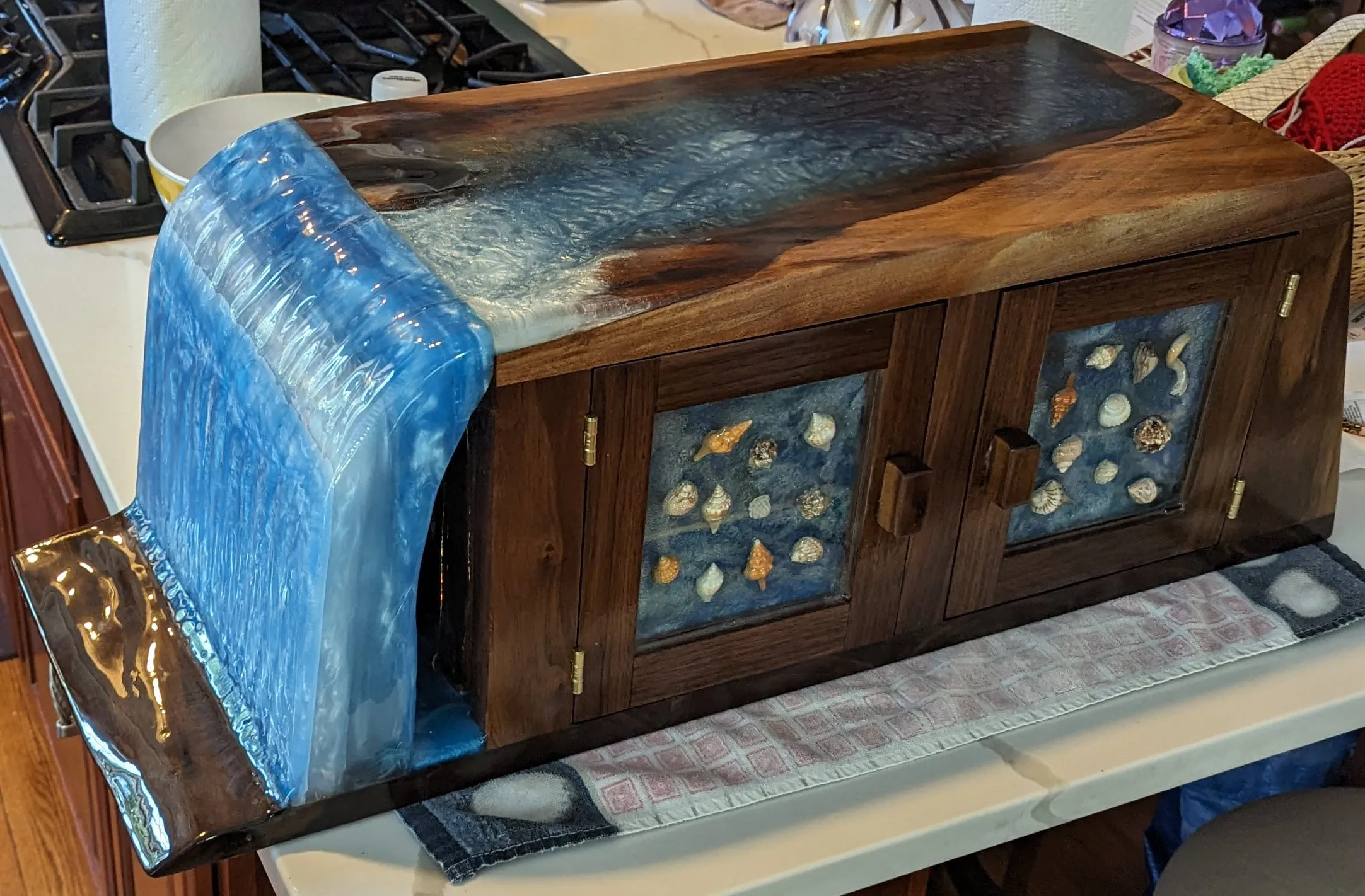 The Waterfall Cabinet — Finished cabinet with the waterfall end and shell-panel doors