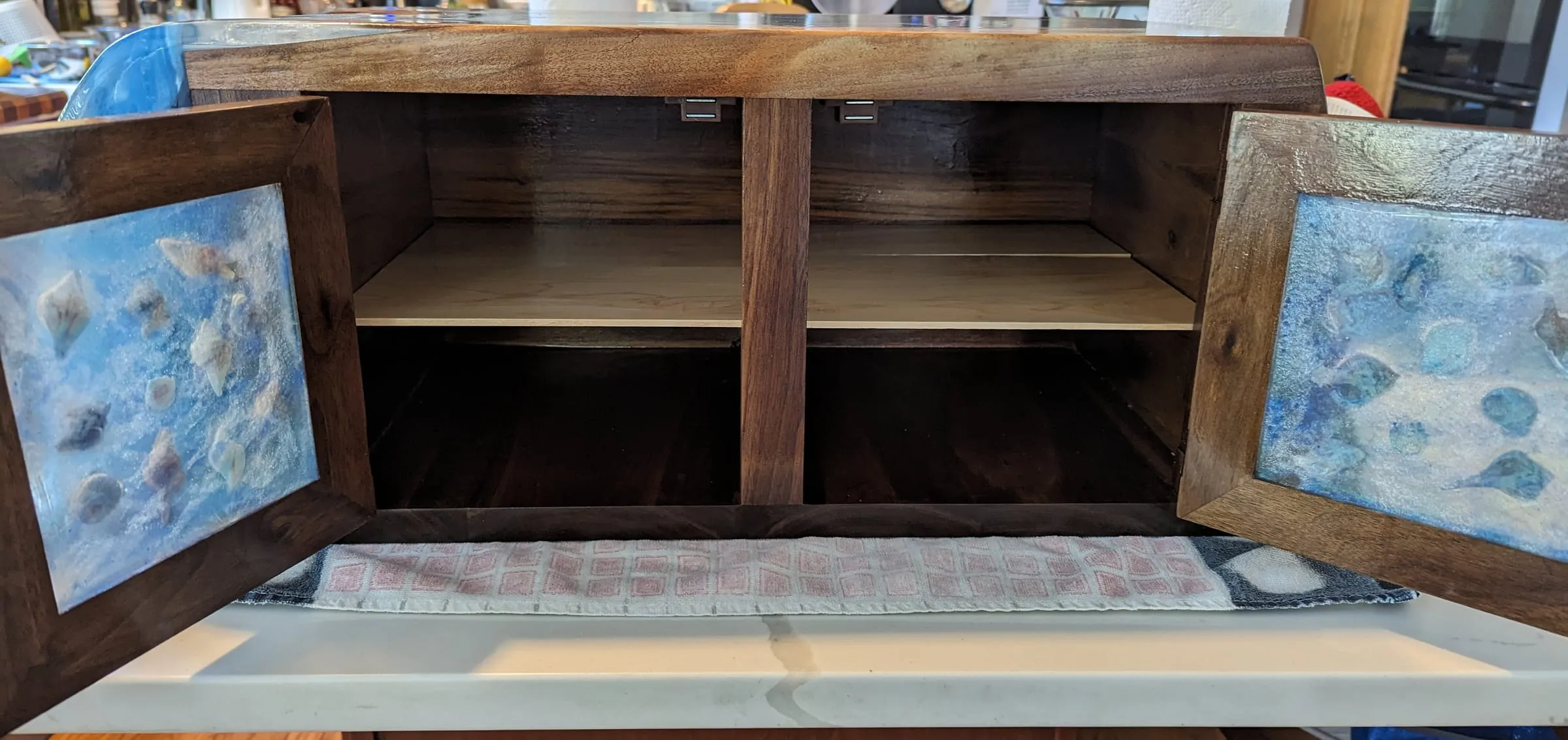 The Waterfall Cabinet — Doors open: shelves and a center divider
