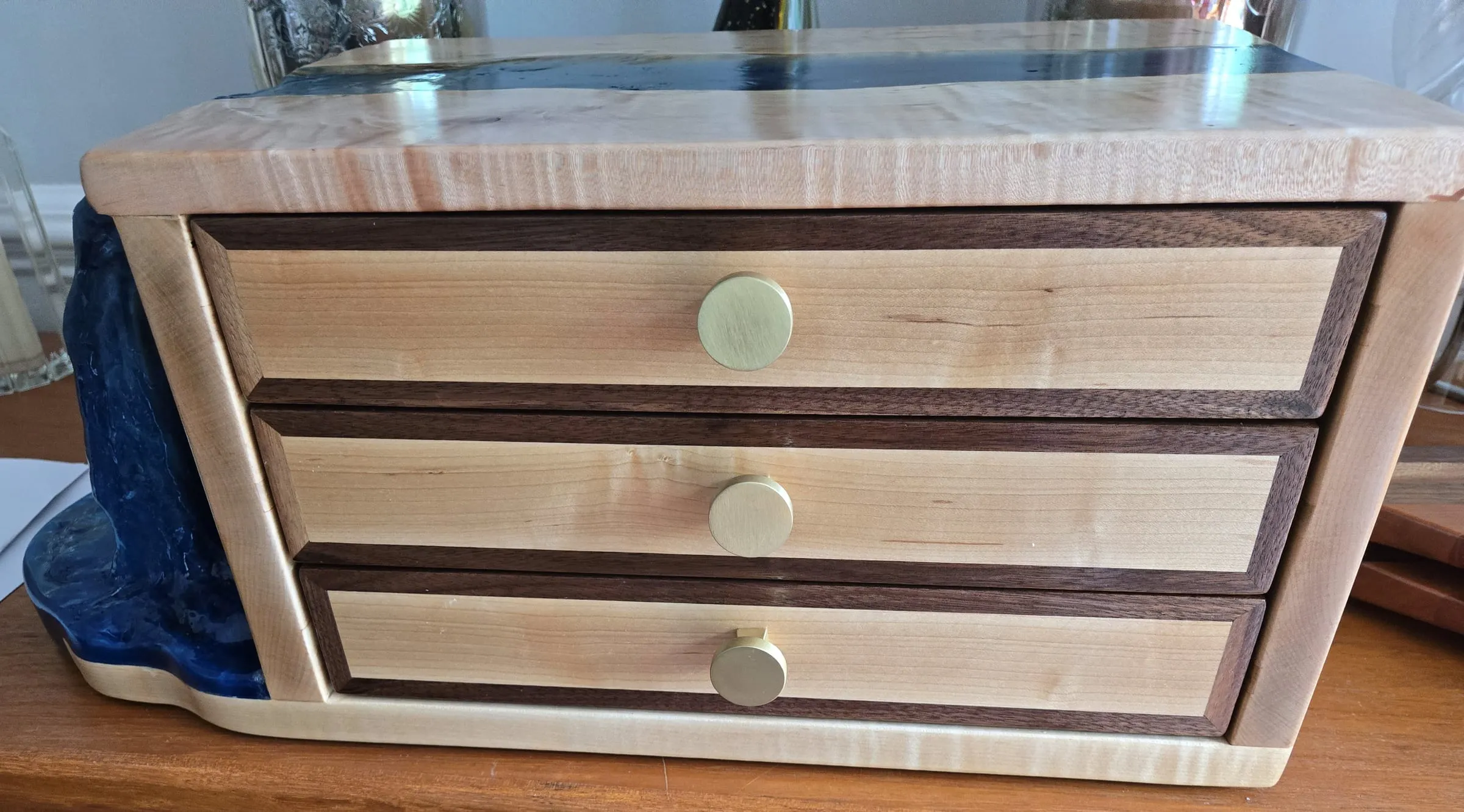 Waterfall Jewelry Box — Front view: three drawers, brass knobs and the waterfall at the left
